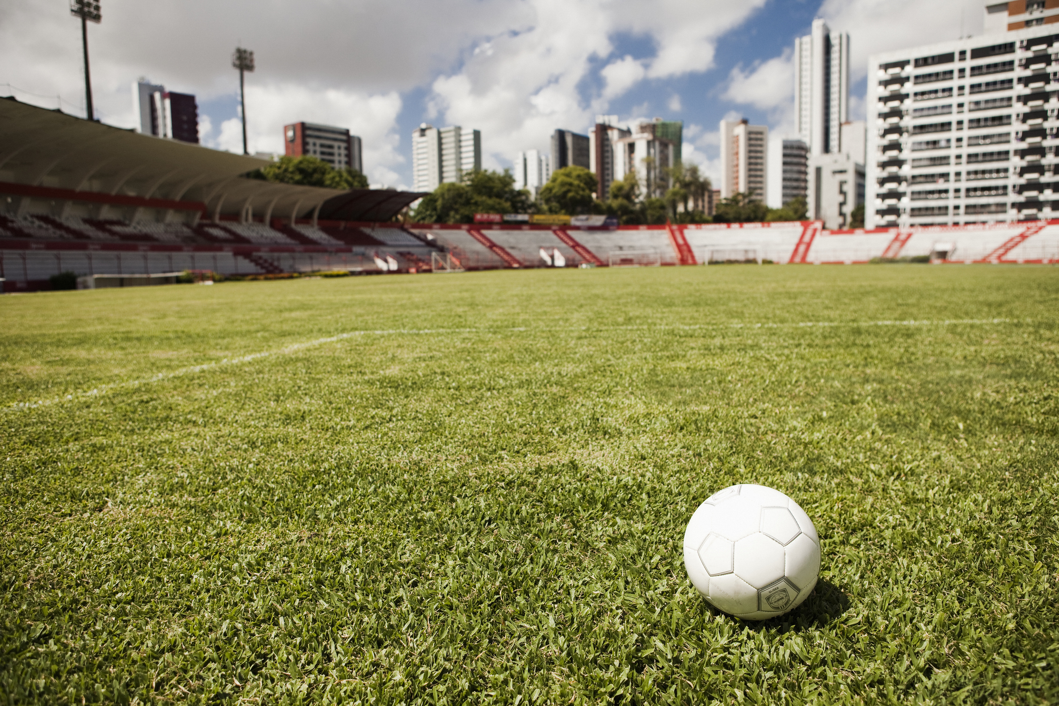 imagem: bola branca em meio a campo de futebol 