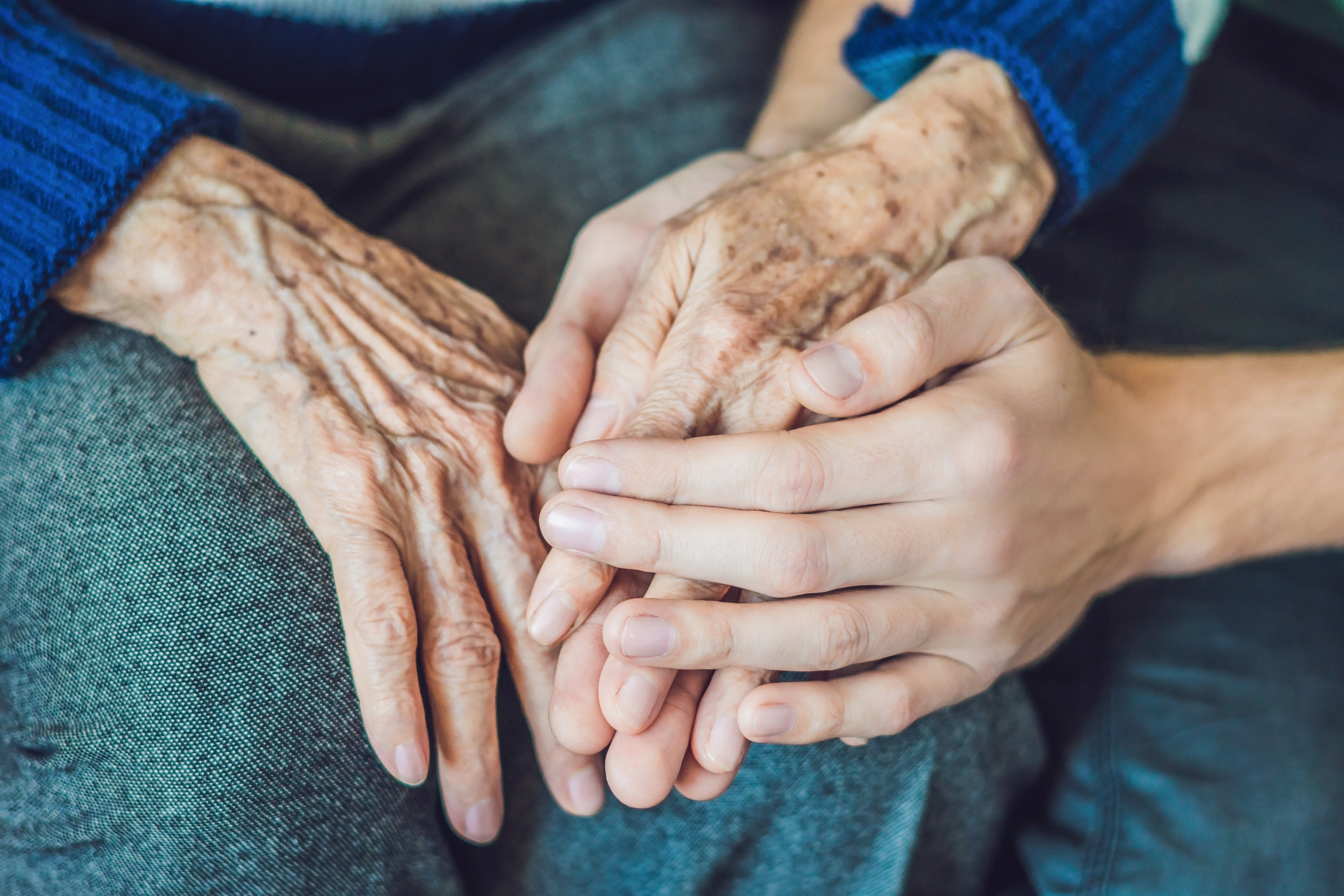 Imagem: pessoa segurando mão de idoso