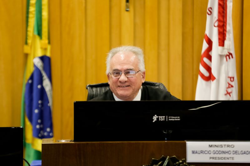 Ministro Maurício Godinho Delgado sentado na sua mesa no sessão.